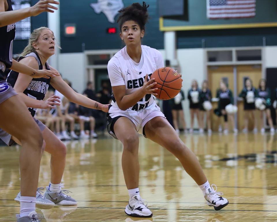 Gisella Maul makes the cut into the lane for Cedar Park against Georgetown in the district finale Tuesday at Cedar Park High School. Cedar Park's offense came alive in the second half en route to a 50-24 victory.