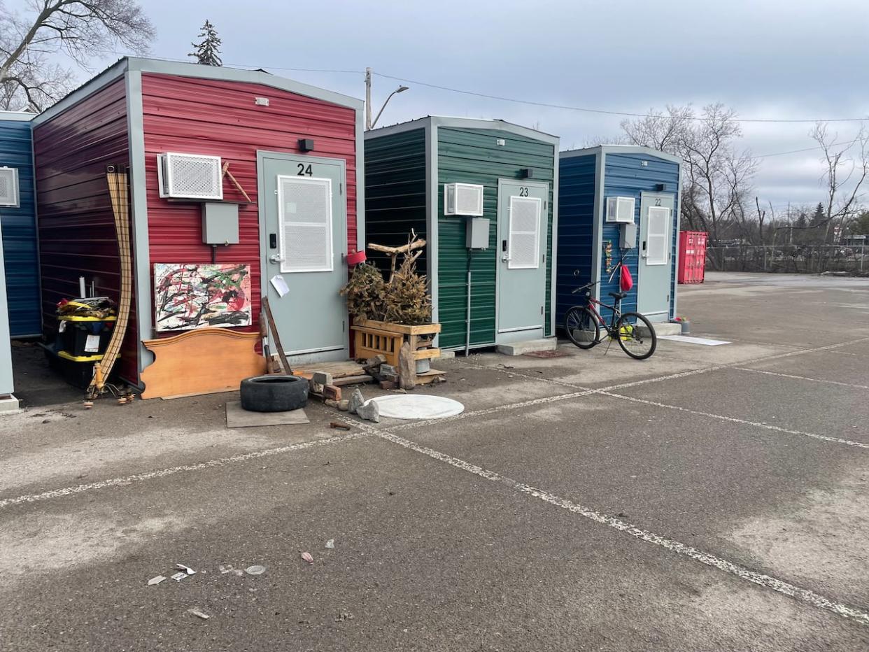 A view of three units in Peterborough's Modular Bridge Housing Community project on a former parking lot. (Lorenda Reddekopp/CBC - image credit)