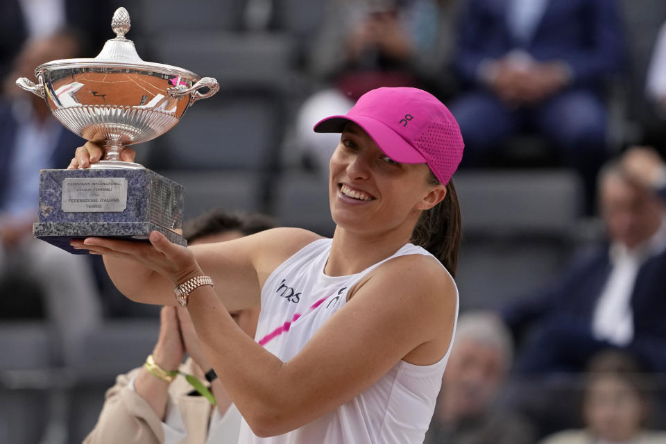 Iga Swiatek, of Poland, holds her trophy after defeating Aryna Sabalenka, of Belarus, in the Italian Open tennis tournament final match at Rome's Foro Italico, Saturday, May 18, 2024. Swiatek won 6-2/6-3. (AP Photo/Alessandra Tarantino)