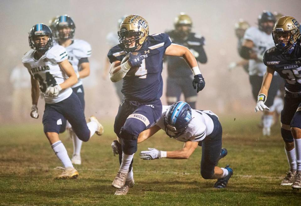 Central Catholic’s Julian Lopez escapes Bullard defenders on a run during the CIF Division II Northern California Regional Championship game at Central Catholic High School in Modesto, Calif., Dec. 3, 2021.