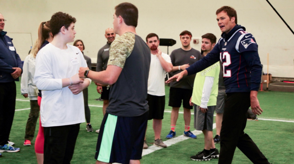 Tom Brady, far right, has returned to the New England Patriots after spending the offseason away from team activities. Here he takes part in a Patriots’ “fantasy camp” event on Monday, with minicamp beginning Tuesday. (New England Patriots/Twitter)