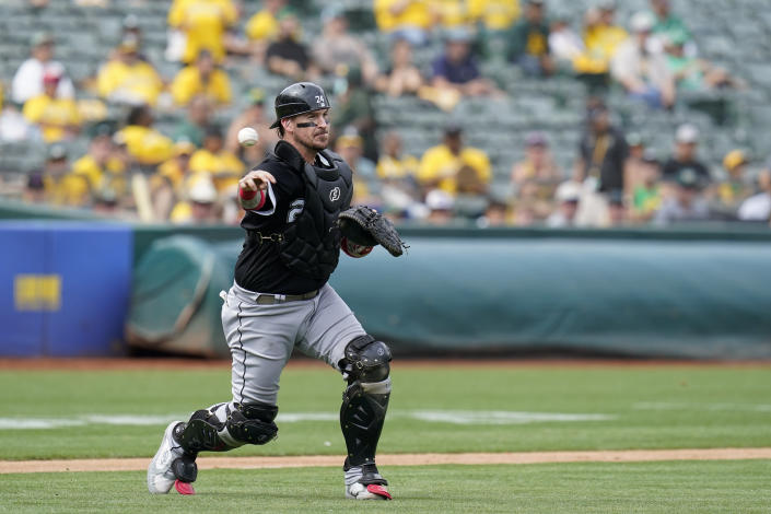 Chicago White Sox catcher Yasmani Grandal throws to first base for an out against Oakland Athletics' Nick Allen during the fifth inning of a baseball game in Oakland, Calif., Sunday, Sept. 11, 2022. (AP Photo/Godofredo A. Vásquez)