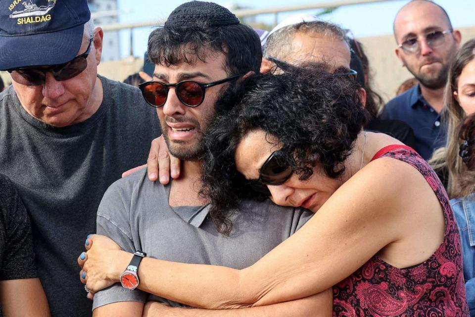 PHOTO: Ido the husband of Israeli-French citizen Celine Ben David Nagar, killed during last week's attack by Hamas militants into Israel, is comforted during her funeral in Holon, south of Tel Aviv on October 17, 2023. (Gil Cohen-magen/AFP via Getty Images)