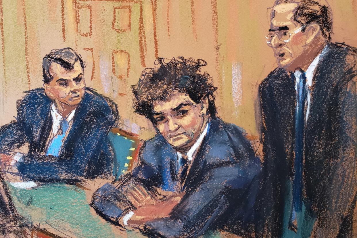 A courtroom sketch of a curly-haired man in a blue suit, crossing his arms and looking tense, with a male lawyer on either side of him.