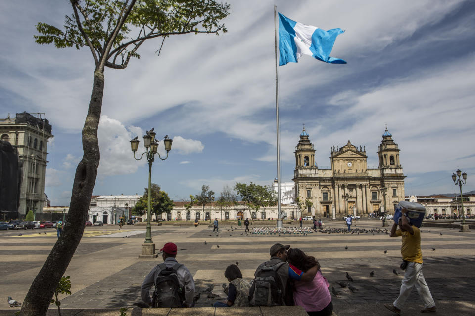 People spend their afternoon in the central park in Guatemala City, Friday, July 26, 2019. The Trump administration signed an agreement with Guatemala Friday that will restrict asylum applications to the U.S. from Central America. (AP Photo/ Oliver de Ros)