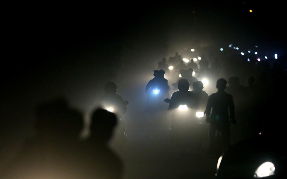 In this 2017 file photo, motorists ride through a thick blanket of smog and dust on the outskirts of New Delhi, India, with microscopic particles spiking at times to 75 times the level considered safe by the World Health Organization. According to a scientific report from the United Nations released on Wednesday, March 13, 2019, the planet is becoming an increasing unhealthy place for people.