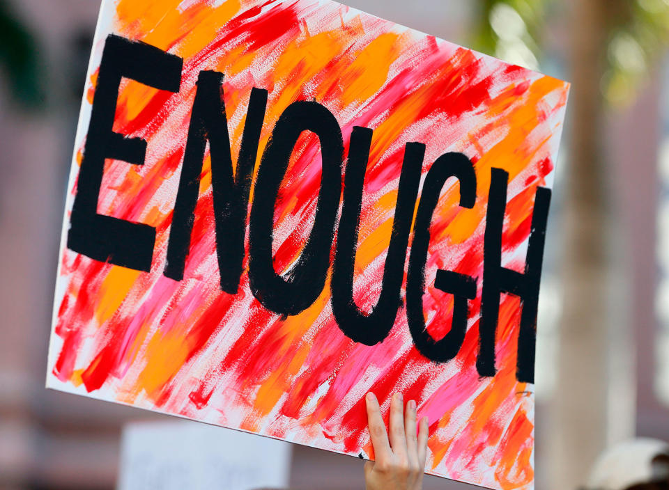 <p>Protesters hold signs at a gun control at the Broward County Federal Courthouse in Fort Lauderdale, Fla., on Feb. 17, 2018. (Photo: Rhona Wise/AFP/Getty Images) </p>