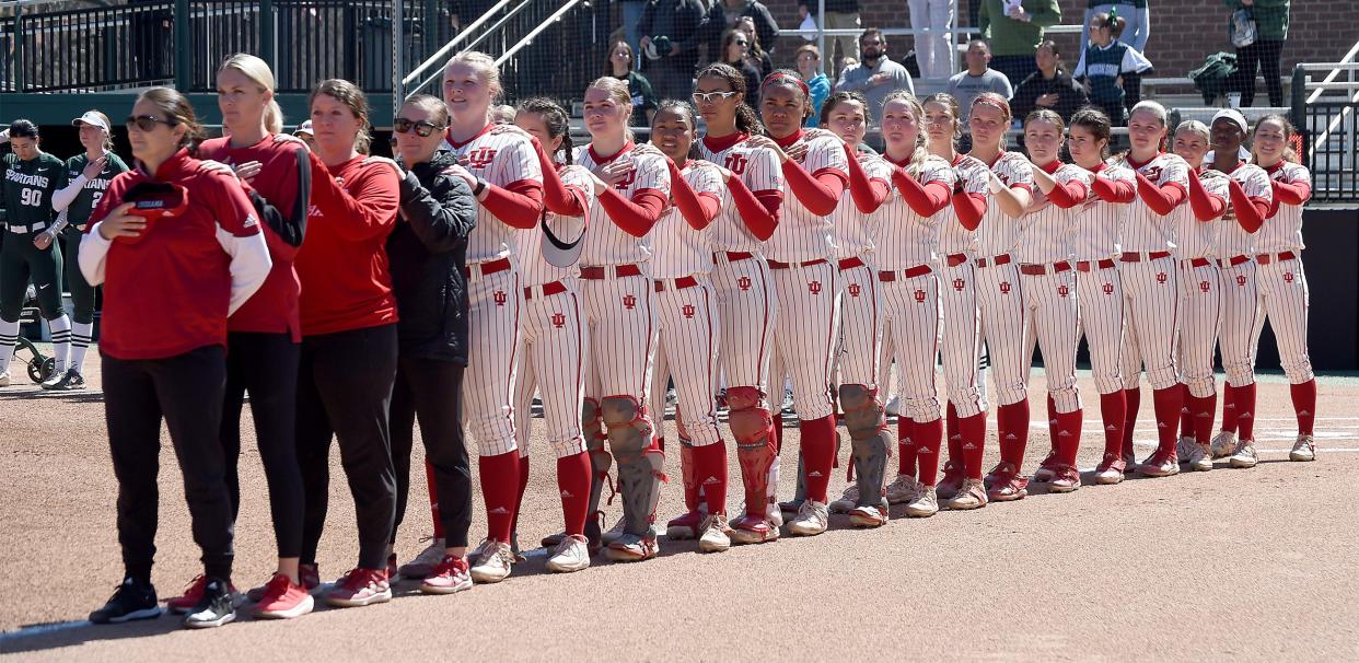Indiana University freshman Aly VanBrandt, former player for the Whiteford Bobcats, who bats fifth, line-up with her teammates and coaches for the National Anthem at MSU Saturday, April 6, 2024.