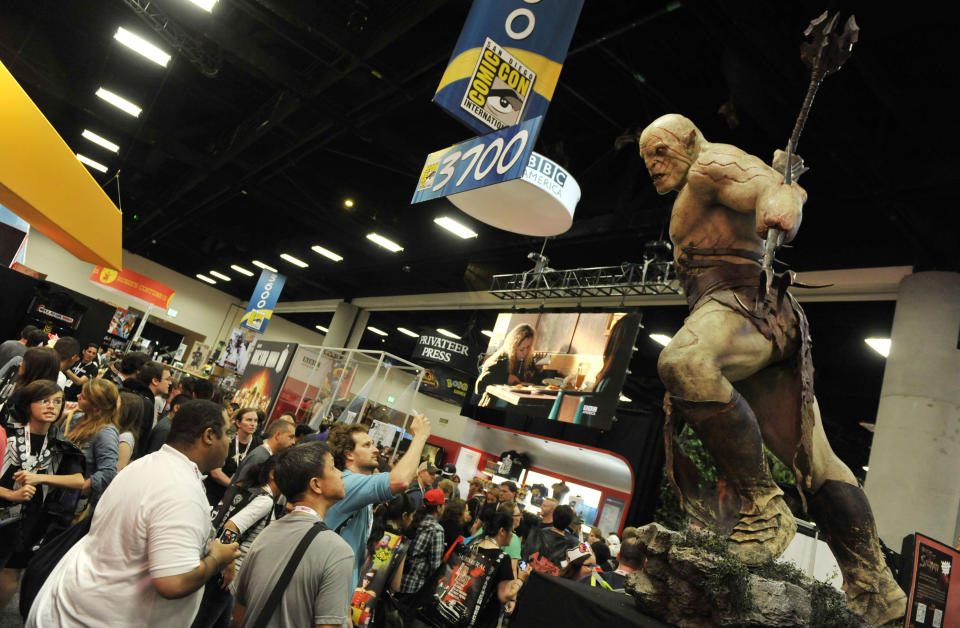 A model looms over Comic-Con attendees during the Preview Night event on Day 1 of the 2013 Comic-Con International Convention on Wednesday, July 17, 2013 in San Diego, Calif. (Photo by Chris Pizzello/Invision/AP)