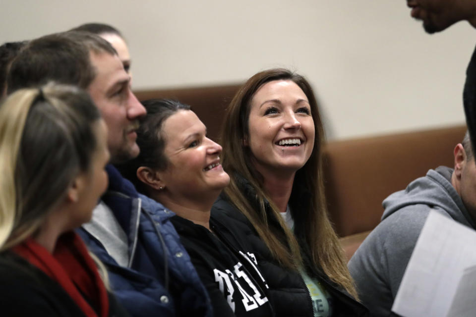 Jamie Cline, right, recovering from a 10-year heroin addiction, smiles as she greets a defense attorney before a drug court session in Thurston County Superior Court Tuesday, Dec. 17, 2019, in Olympia, Wash. While in a jail work-release program this past spring, Cline took a medication called buprenorphine. A new treatment philosophy called "medication first" scraps requirements for counseling, abstinence or even a commitment to recovery. (AP Photo/Elaine Thompson)