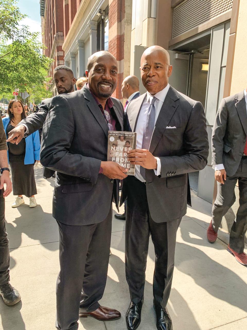 Bruce Jackson posing with his memoir, "Never Far from Home," and New York City Mayor Eric Adams. Jackson serves on the mayor’s corporate counsel committee.