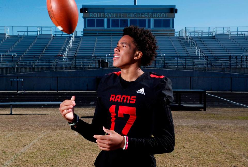 Byrum Brown, quarterback at Rolesville High School in Wake Forest, N.C., poses on the field Tuesday, November 30, 2021.