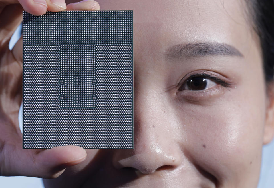 A Kunpeng 920 chip is displayed during an unveiling ceremony in Shenzhen, China, Monday, Jan. 7, 2019. Chinese telecom giant Huawei unveiled a processor chip for data centers and cloud computing as it expands into an emerging global market despite Western warnings the company might be a security risk. (AP Photo/Vincent Yu)