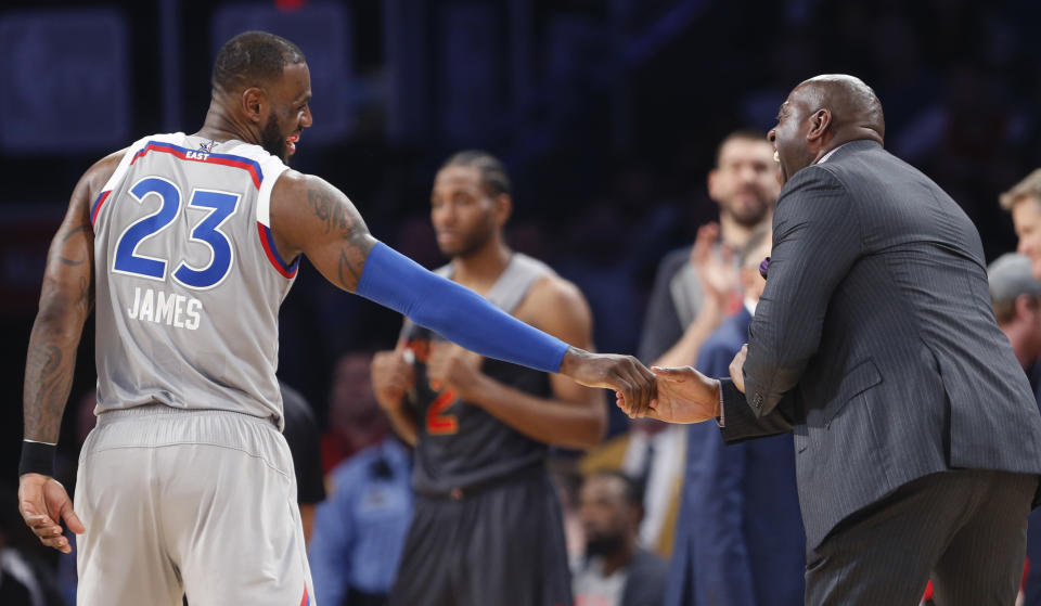 Former NBA player Magic Johnson reacts as he talks with Eastern Conference LeBron James of the Cleveland Cavaliers (23) during the first half of the NBA All-Star basketball game in New Orleans, Sunday, Feb. 19, 2017. (AP Photo/Gerald Herbert)