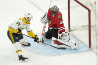 Chicago Blackhawks goaltender Malcolm Subban (30) makes a pad save on a shot by Nashville Predators' Tanner Jeannot during the third period of an NHL hockey game Wednesday, April 21, 2021, in Chicago. (AP Photo/Charles Rex Arbogast)