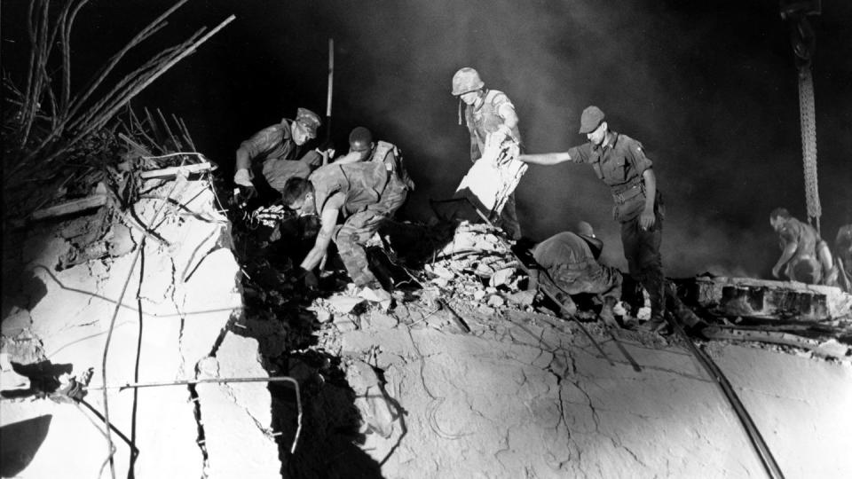 In this Monday, Oct. 24, 1983, file photo, U.S. Marines and an Italian soldier, right, dig through the rubble of the battalion headquarters, in Beirut, Lebanon, working around the clock searching for victims of the suicide truck bomb attack against the U.S. Marine barracks on Oct. 23, 1983. (Bill Foley, File/The Associated Press