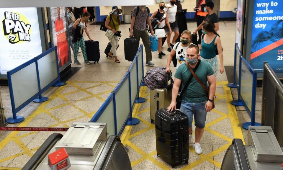 Passengers arrive at Heathrow from Spain.