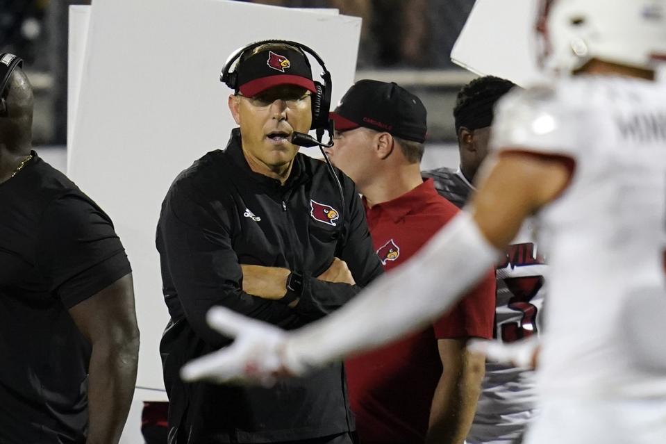 Louisville head coach Scott Satterfield directs players on the field during the first half of an NCAA college football game against Central Florida, Friday, Sept. 9, 2022, in Orlando, Fla. (AP Photo/John Raoux)