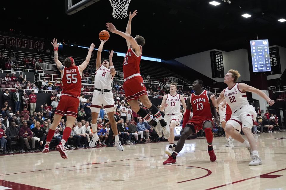 Stanford guard Andrej Stojakovic (2) drives to the basket between Utah guard Gabe Madsen (55) and guard Luka Tarlac (21) during the second half of an NCAA college basketball game, Sunday, Jan. 14, 2024, in Stanford, Calif. | Godofredo A. Vásquez, Associated Press