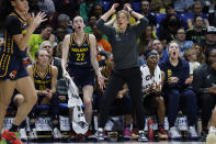 CORRECTS FROM CAITLYN TO CAITLIN - Indiana Fever guard Caitlin Clark (22) and head coach Christine Sides, center right, react after a play during the second half of an WNBA basketball game against the Dallas Wings in Arlington, Texas, Friday, May 3, 2024. (AP Photo/Michael Ainsworth)