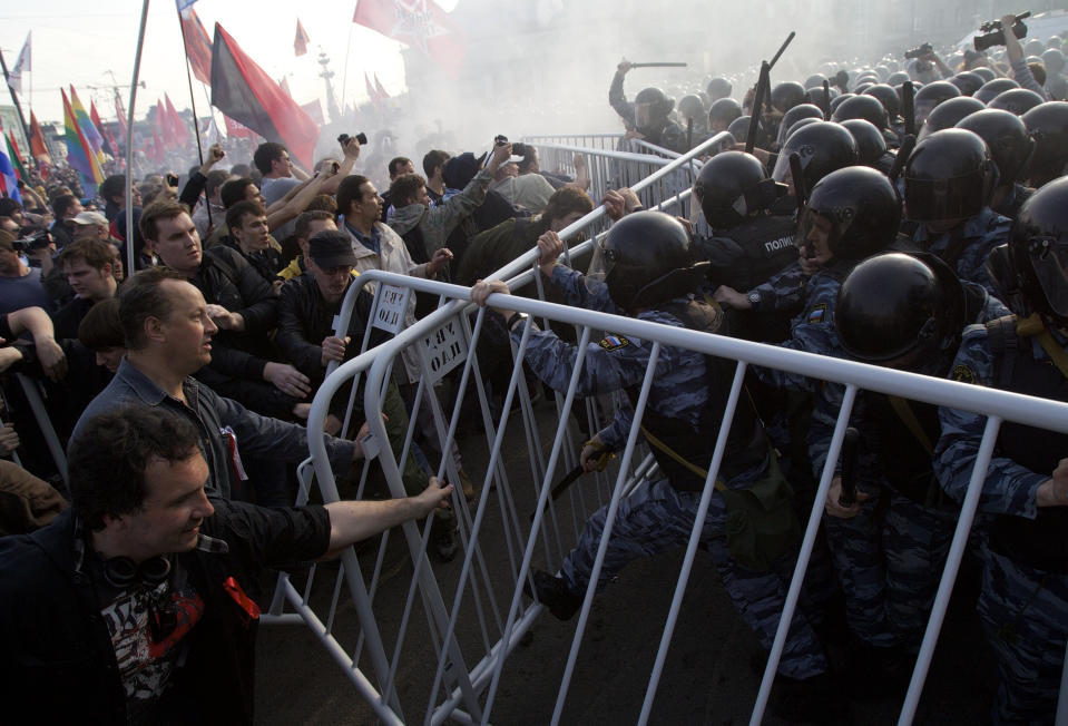 FILE - Russian riot police try to disperse opposition protesters on the eve of Vladimir Putin's inauguration as president, in downtown Moscow on May 6, 2012. Vladimir Putin on Friday Dec. 8, 2023 moved to prolong his repressive and unyielding grip on Russia for another six years, announcing his candidacy in the 2024 presidential election that he is all but certain to win. (AP Photo/Ivan Sekretarev, File)