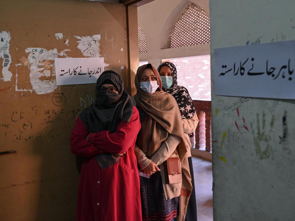 Women stand in a queue as they wait to cast their ballots to vote at a polling station during Pakistan’s national elections in Lahore on February 8, 2024 (AFP via Getty Images)