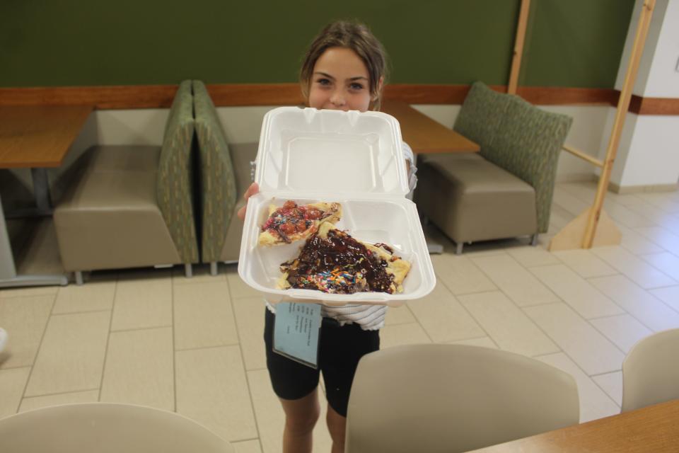 Kiley Puster, 13, of Fremont shows off a dessert pizza she made in Terra State Community College's KidsCollege's Pizza Palooza class Wednesday.