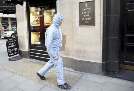 A police forensic officer walks to a safe deposit building on Hatton Garden in central London April 7, 2015. Burglars are believed to have broken into the Hatton Garden Safe Deposit company over the Easter weekend, local media reported. REUTERS/Neil Hall