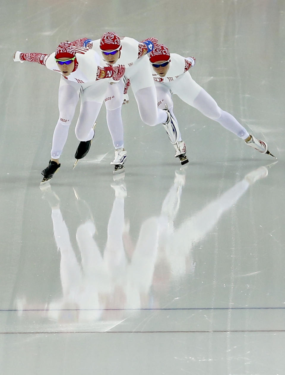 Team Russia's Yekaterina Lobysheva, left, Yulia Skokova, center and Olga Graf compete in the women's speedskating team pursuit quarterfinals at the Adler Arena Skating Center during the 2014 Winter Olympics in Sochi, Russia, Friday, Feb. 21, 2014. (AP Photo/Patrick Semansky)