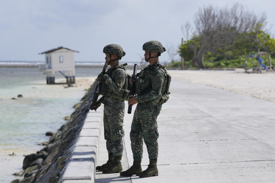 Philippine troops secure an area at the Philippine-occupied Thitu island, locally called Pag-asa island, on Friday, Dec. 1, 2023 at the disputed South China Sea. The Philippine coast guard inaugurated a new monitoring base Friday on a remote island occupied by Filipino forces in the disputed South China Sea as Manila ramps up efforts to counter China's increasingly aggressive actions in the strategic waterway. (AP Photo/Aaron Favila)