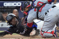 Washington Nationals catcher Keibert Ruiz (20) tags out Miami Marlins' Nick Gordon as he tried to take home during the fourth inning of a baseball game, Friday, April 26, 2024, in Miami. (AP Photo/Wilfredo Lee)