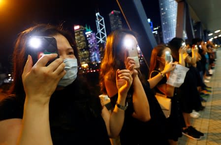 Protesters light up their smartphones as they form a human chain during a rally to call for political reforms in Hong Kong's Central district