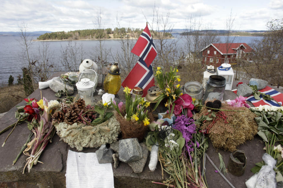 Norway's national flags, flowers and candles are arranged at a memorial site northwest of Oslo that commemorates the 69 people killed by a gunman at a Labour Party youth camp in July 2011. (Photo: Ints Kalnins/Reuters)