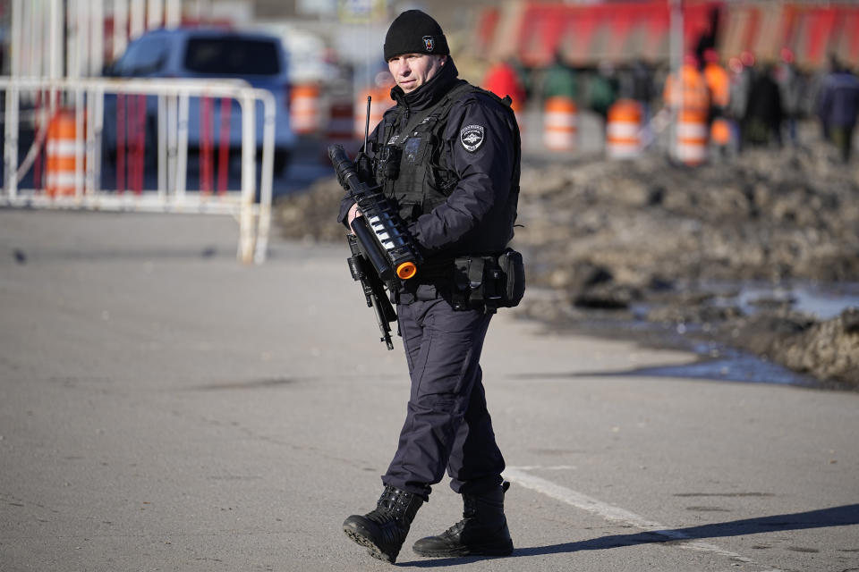 A police officer stands guard holding an anti-drone rifle in the outskirts of Moscow, Russia, Monday, March 25, 2024 near the Crocus City Hall, which was hit by a terrorist attack on Friday. There were calls Monday for harsh punishment for those behind the attack on the Rossiya concert hall that killed more than 130 people as authorities combed the burnt-out ruins of the shopping and entertainment complex in search of more bodies. (AP Photo/Alexander Zemlyanichenko)