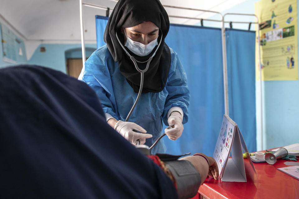 File - A Save the Children midwife provides Zarmina, 25, who is five months pregnant, with a pre-natal check-up in Jawzjan province in northern Afghanistan, Sunday, Oct. 2, 2022. (Save the Children via AP, File)