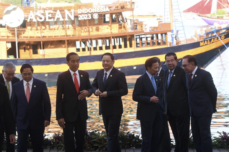 From left to right, Thailand's Deputy Prime Minister and Foreign Minister Don Pramudwinai, Vietnam's Prime Minister Pham Minh Chinh, Indonesian President Joko Widodo, Laotian Prime Minister Sonexay Siphandone, Brunei's Sultan Hassanal Bolkiah, Cambodia's Prime Minister Hun Sen and Malaysian Prime Minister Anwar Ibrahim leave their positions after a family photo session at the 42nd ASEAN Summit in Labuan Bajo, East Nusa Tenggara, Indonesia, Wednesday, May 10, 2023. (Akbar Nugroho Gumay/Pool Photo via AP)
