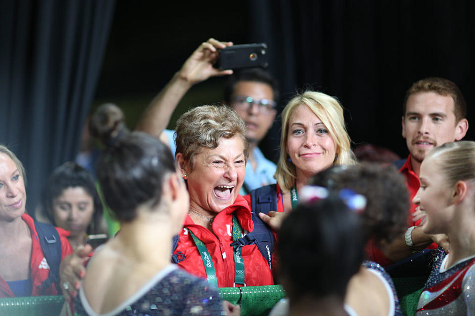 Marta Karolyi hugs the U.S. women's gymnasts after their gold medal in the 2016 team competition. (Getty)