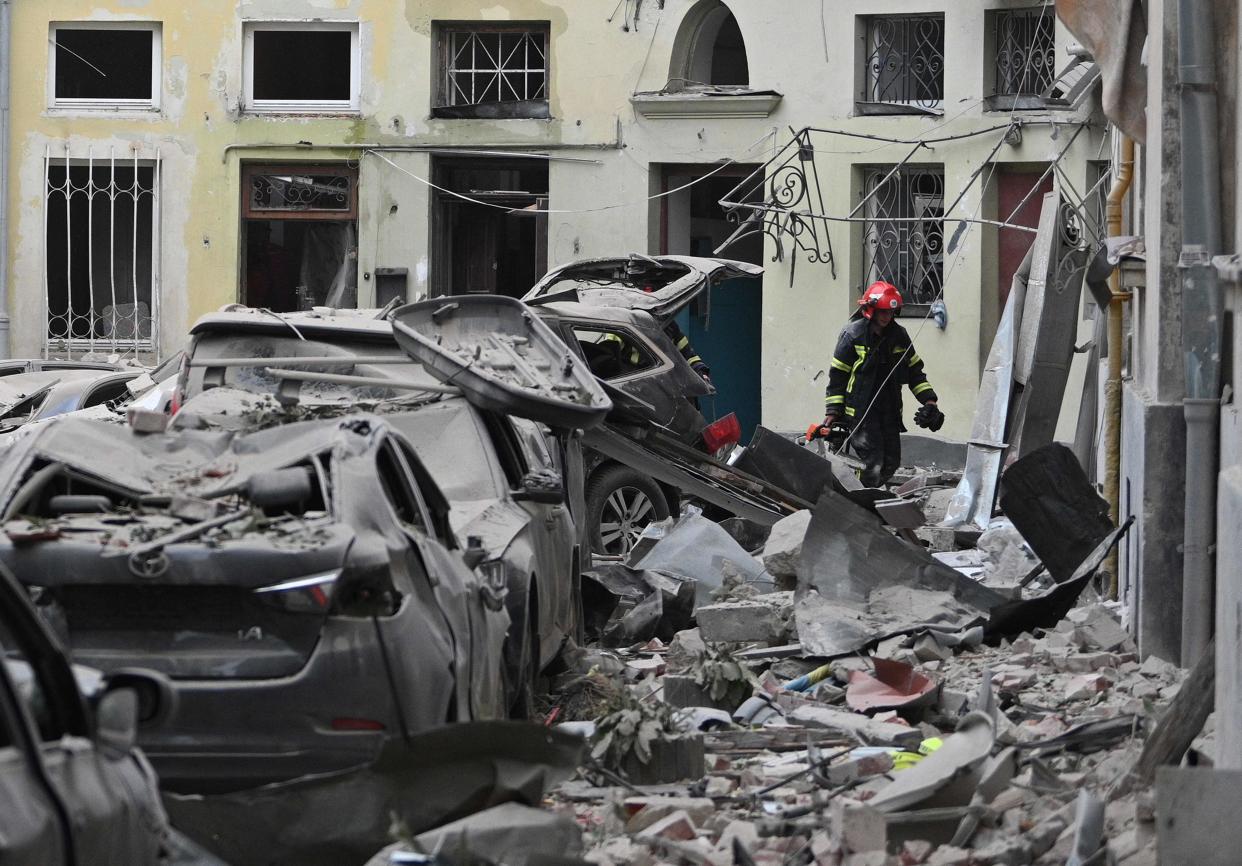 A rescuer works in an apartment building partially destroyed (AFP via Getty Images)