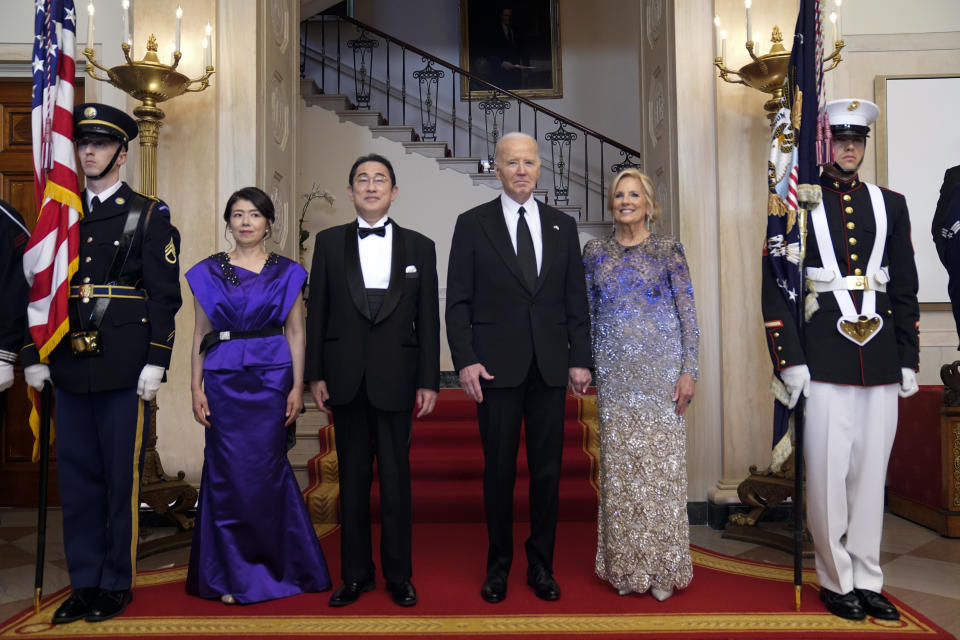 President Joe Biden and first lady Jill Biden pose for a photo with Japanese Prime Minister Fumio Kishida and his wife Yuko Kishida by the Grand Staircase in the Cross Hall of the White House during a State Dinner at the White House, Wednesday, April 10, 2024, in Washington. (AP Photo/Evan Vucci)