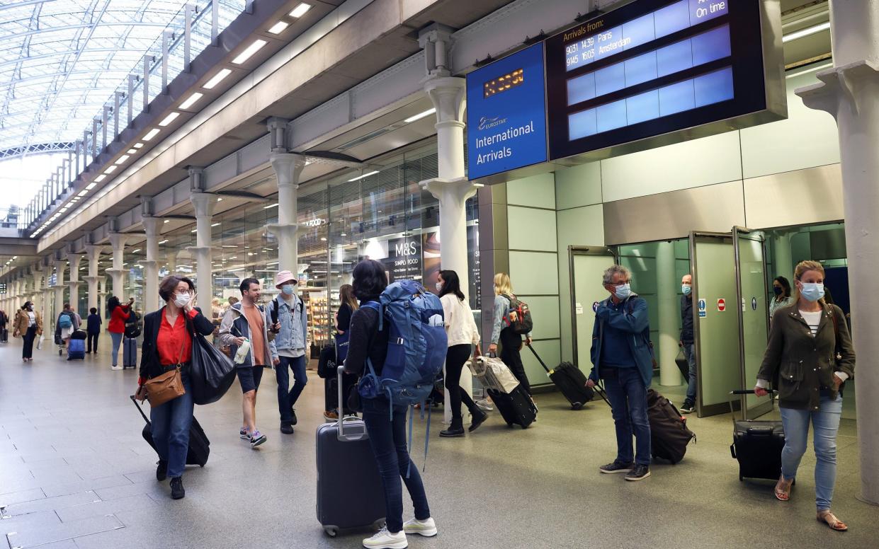 Travellers exit from an arrivals gate at St Pancras International station following the arrival of a Eurostar train from Paris - Henry Nicholls/Reuters