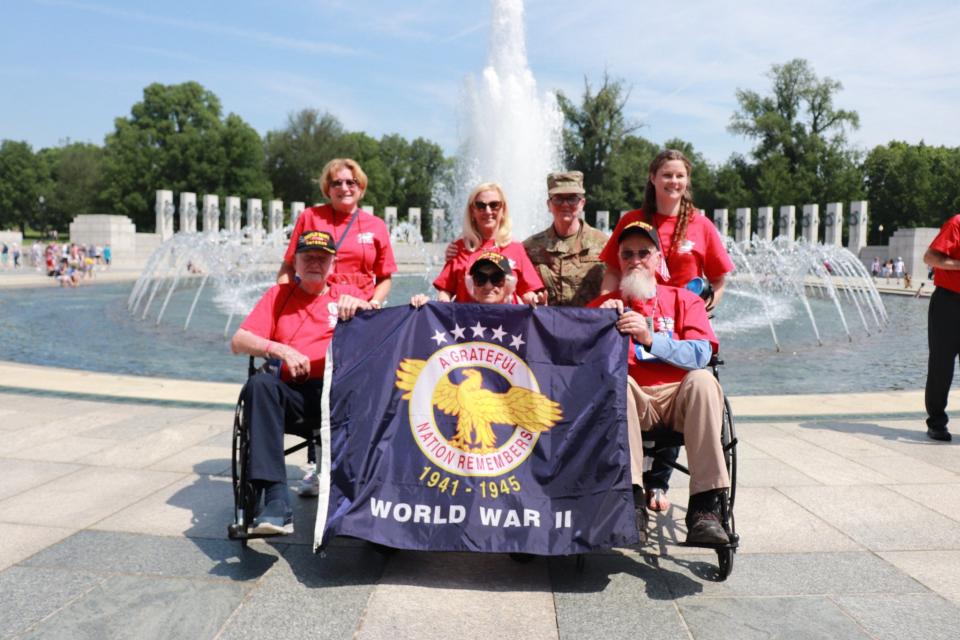 World War II veterans, including 98-year-old Edith Joy Casino, front center, gather at the World War II memorial in Washington during their Honor Flight viist.