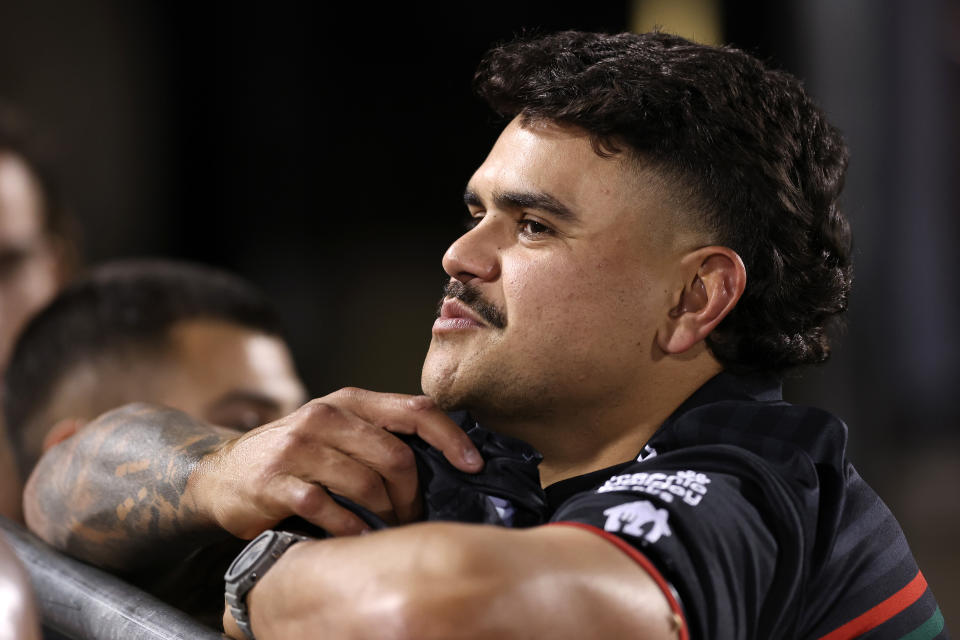 Latrell Mitchell watches on.