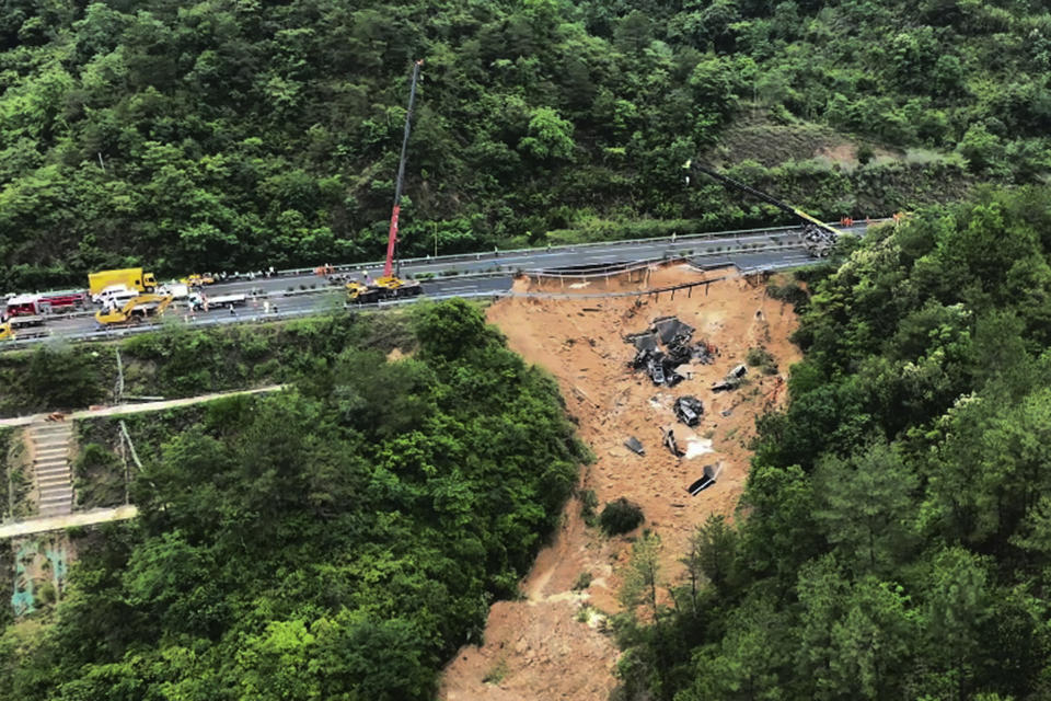 In this photo released by Xinhua News Agency, an aerial photo shows rescuers working at the site of a collapsed road section of the Meizhou-Dabu Expressway in Meizhou, south China's Guangdong Province, Wednesday, May 1, 2024. A section of a highway collapsed early Wednesday in southern China, sending cars tumbling and leaving more than a dozen of people dead, according to state media. (Xinhua News Agency via AP)