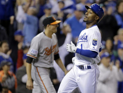 Jarrod Dyson (right) scored the go-ahead run on a sacrifice fly by Billy Butler. (AP)