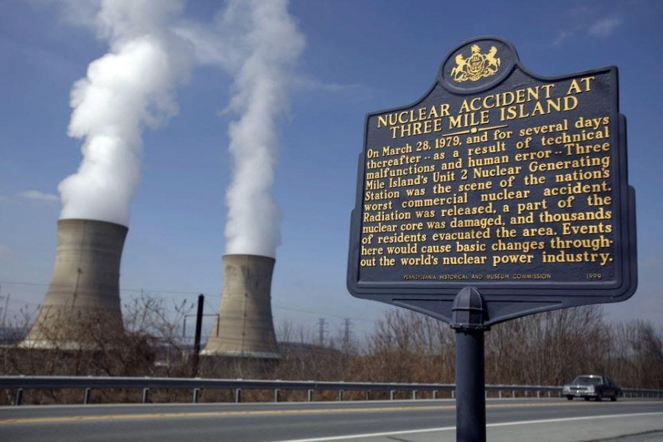 A historic marker is seen as the cooling towers of Three Mile Island's Unit 1 Nuclear Power Plant pour steam into the sky in Middletown, Pa., March 17, 2009. Three Mile Island's Unit 2 nuclear power plant was the scene of the nation's worst commercial nuclear accident on March 28, 1979.