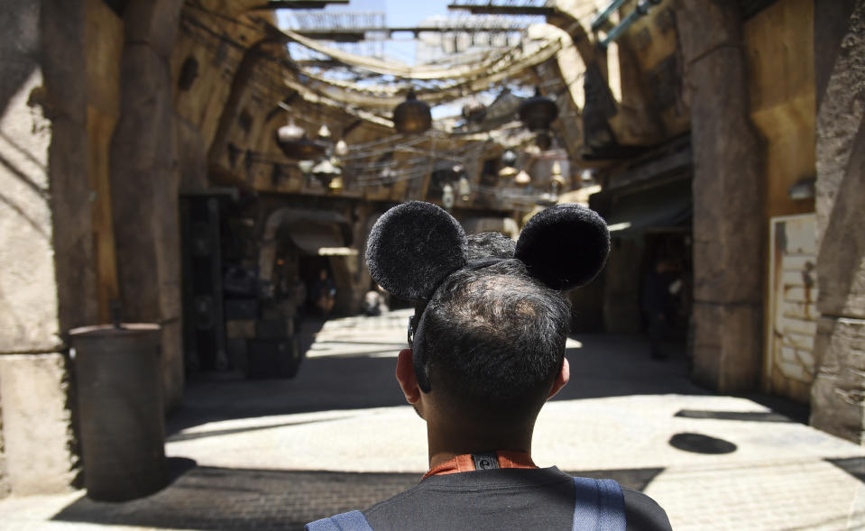 A visitor peers down the marketplace of the Black Spire Outpost during the Star Wars: Galaxy's Edge Media Preview at Disneyland Park, Wednesday, May 29, 2019, in Anaheim, Calif. (Photo by Chris Pizzello/Invision/AP)