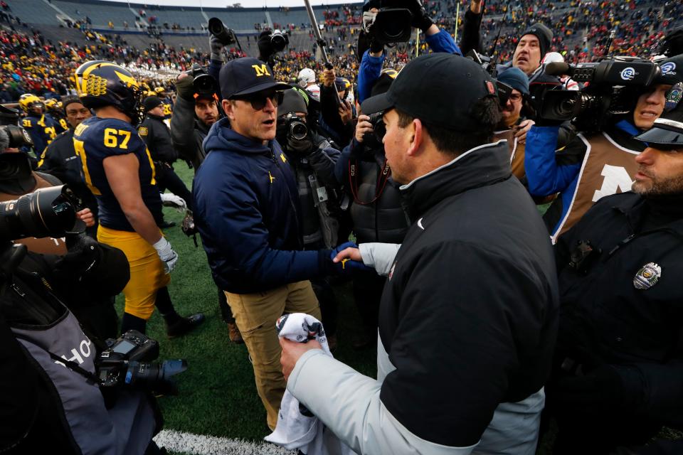 Ohio State coach Ryan Day shakes hands with Michigan coach Jim Harbaugh after the game at Michigan Stadium, Nov. 30, 2019. Ohio State won, 56-27.