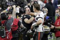 New Orleans Saints quarterback Drew Brees, center left, speaks with Tampa Bay Buccaneers quarterback Tom Brady after an NFL divisional round playoff football game, Sunday, Jan. 17, 2021, in New Orleans. The Buccaneers won 30-20. (AP Photo/Butch Dill)