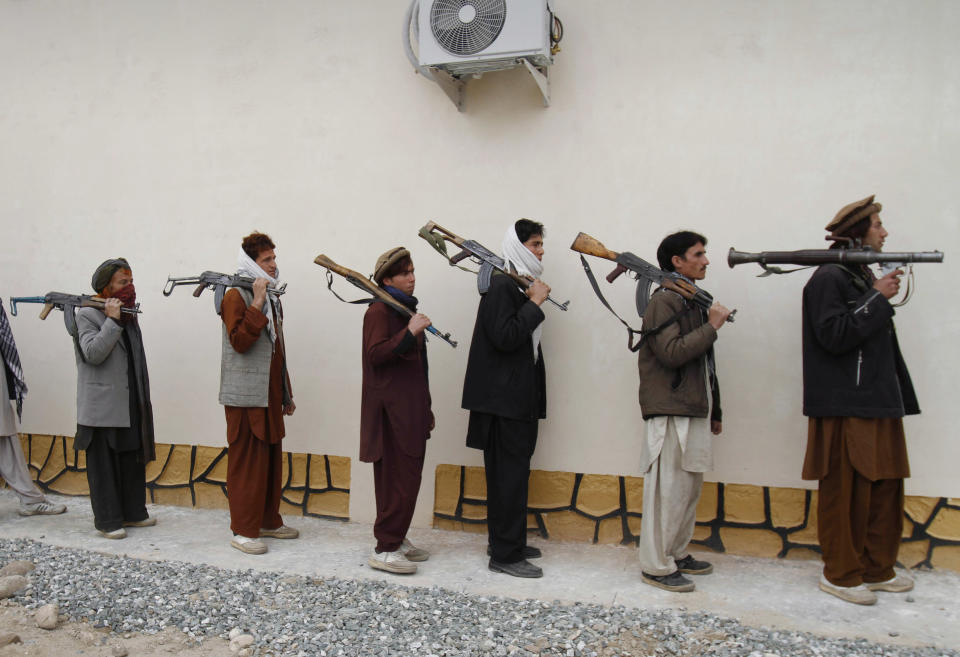 FILE - In this Monday, March 12, 2012 file photo, former Taliban militants line up with their weapons to attend in a joining ceremony with the Afghan government in Mehterlam, Laghman province, east of Kabul, Afghanistan. Secret contacts are again reported to be underway for an Afghanistan peace deal, but neither analysts nor the belligerents see hope they will succeed. (AP Photo/Rahmat Gul, File)