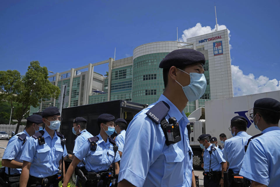 Police gather outside Apple Daily headquarters in Hong Kong after arresting the chief editor and four other senior executives of the newspaper under the national security law on June 17, 2021. Until early April, Mike Hui was a photojournalist for the Apple Daily, a pro-democracy newspaper that shut down following the arrest of five top editors and executives and the freezing of its assets under a national security law that China's ruling Communist Party imposed on Hong Kong as part of the crackdown. (AP Photo/Kin Cheung)